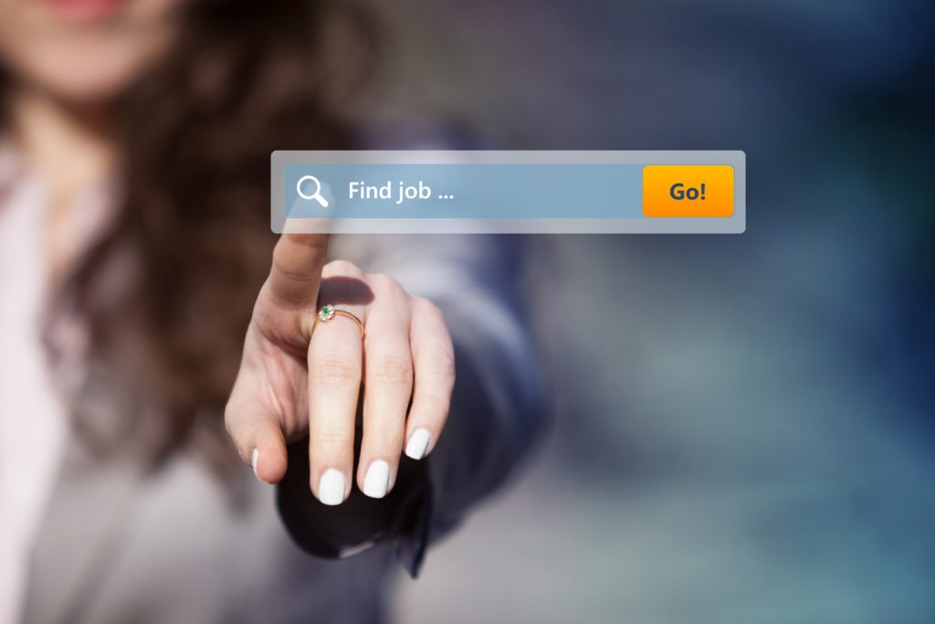 Woman looking through job postings by pressing search button on virtual touch screen.