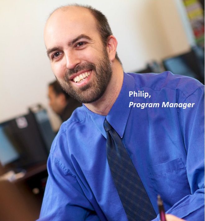 Career Opportunities - Philip, a Program Manager with The Career Foundation, is shown smiling at a team meeting.