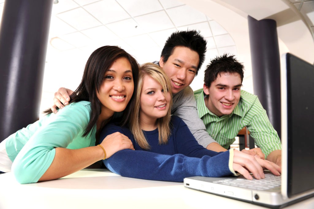 Youth Job Link Program - Diverse college student friends at a laptop.