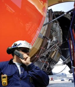 Made in the Trades - A mechanic calls for assistance while repairing the engine of a small airplane.